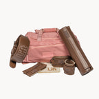 Pink bag with brown accessories on a white background