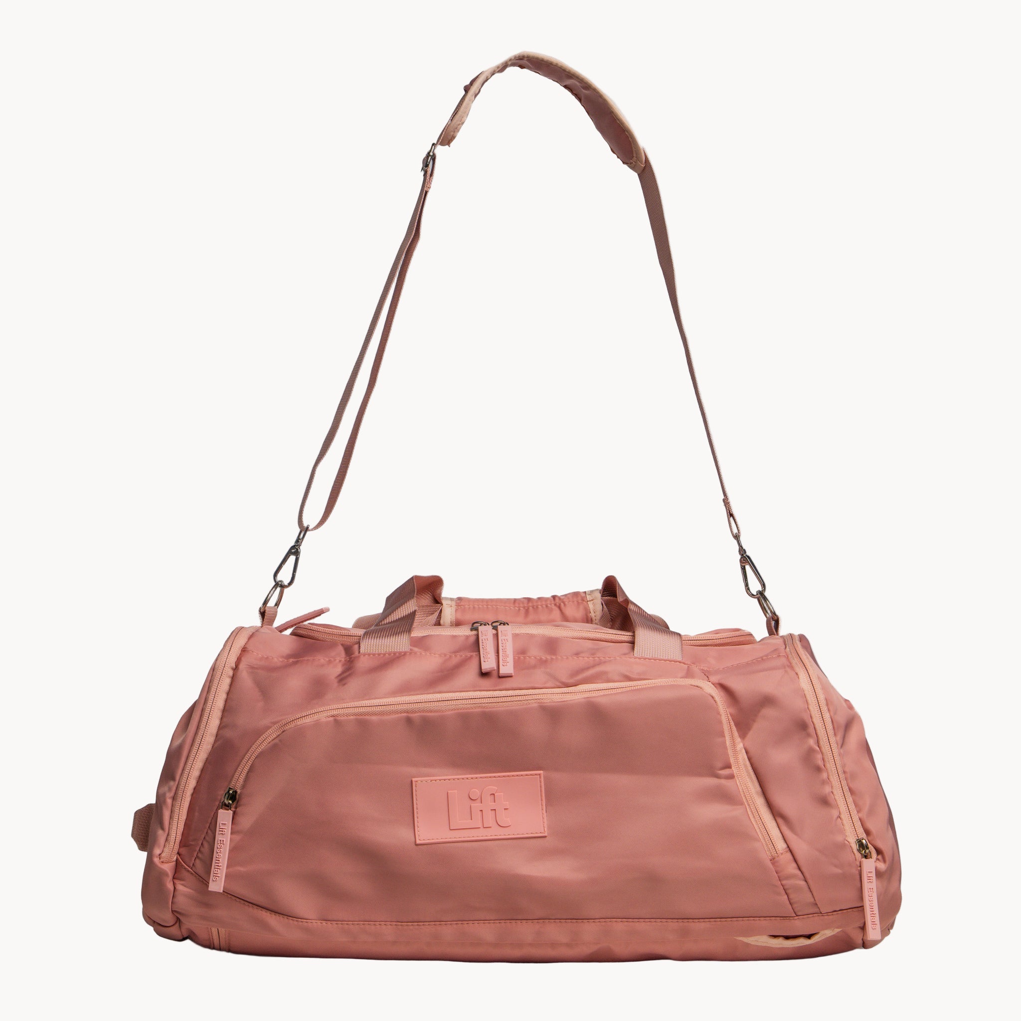 Pink duffel bag with a strap on a white background
