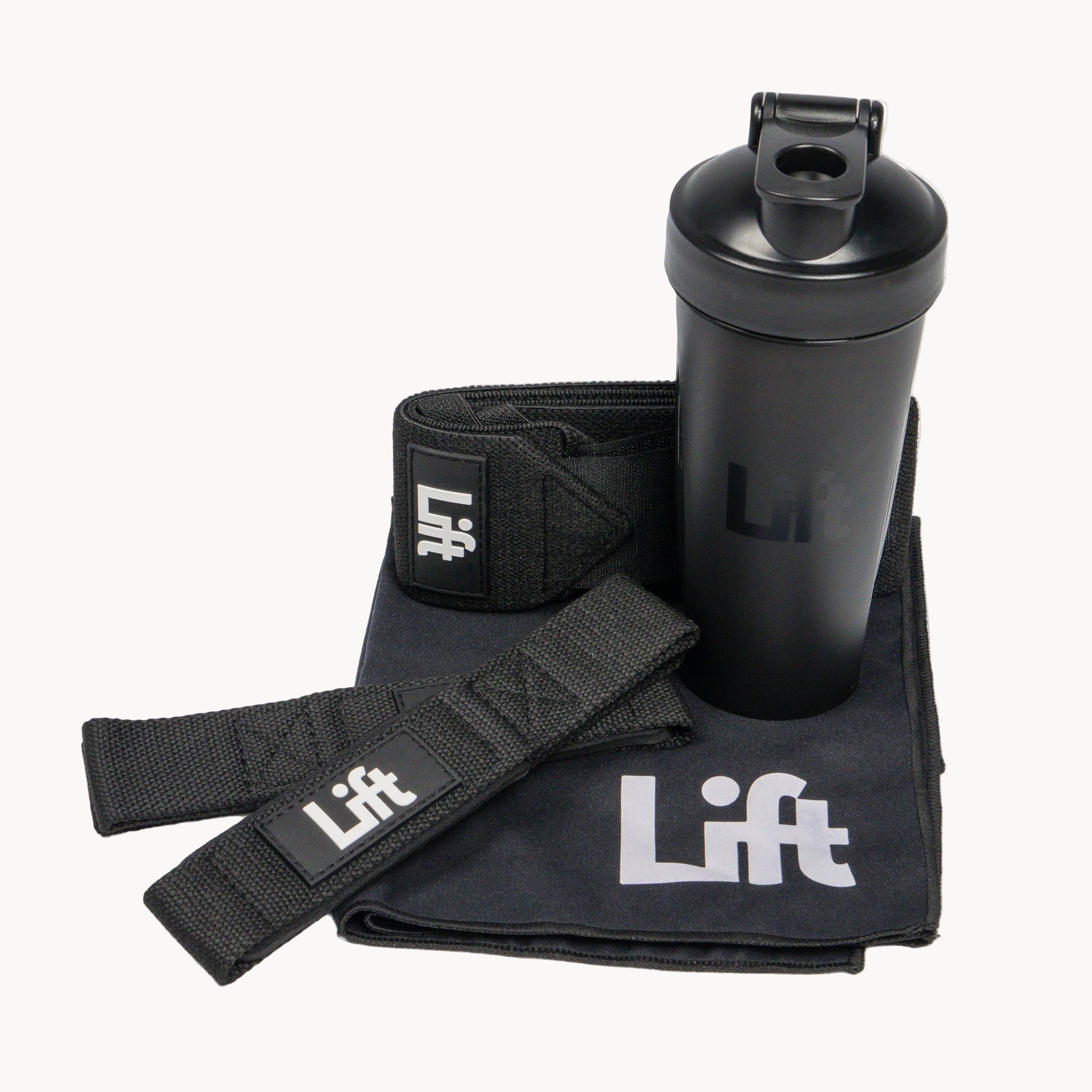 Black shaker bottle, wrist wraps, and towel with 'Lift' branding on a white background